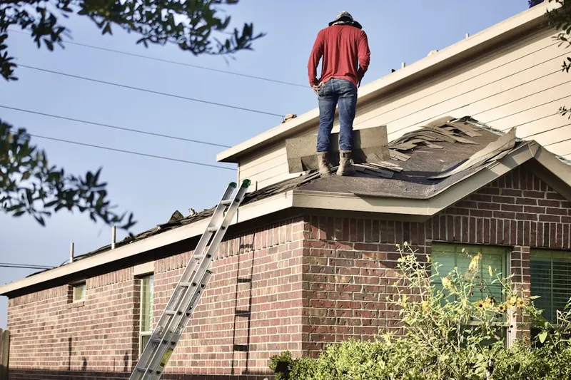 Professional roofer working on a residential roof in Lake Talmadge